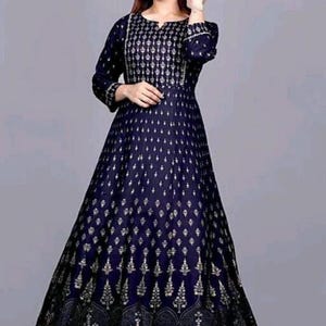 May include: A long, navy blue dress with a gold print. The dress has a round neckline and three-quarter sleeves.