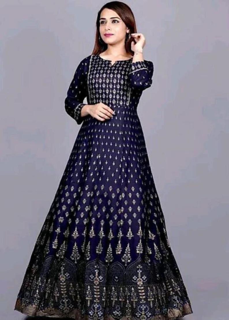 May include: A long, navy blue dress with a gold print. The dress has a round neckline and three-quarter sleeves.