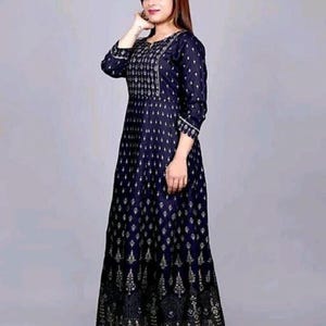 May include: A long, navy blue dress with a gold print. The dress has a round neckline and three-quarter sleeves.