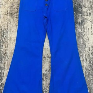 May include: A pair of blue bell-bottom trousers with a button fly and two front pockets.