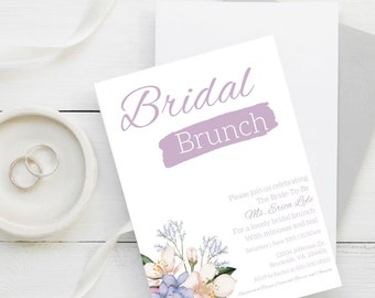 May include: A purple and white bridal brunch invitation with a floral design and the text "Bridal Brunch". The invitation includes the bride-to-be's name, the date and time of the event, and the address. RSVP information is also included.