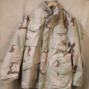 Parka estadounidense con camuflaje desértico, clima frío.