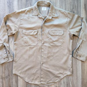 Beige shirt.