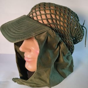 May include: Olive green military-style hat with a brim and a net covering the top. The hat has a neck and face covering. The hat is made of a durable fabric and is designed for protection from the sun and elements.
