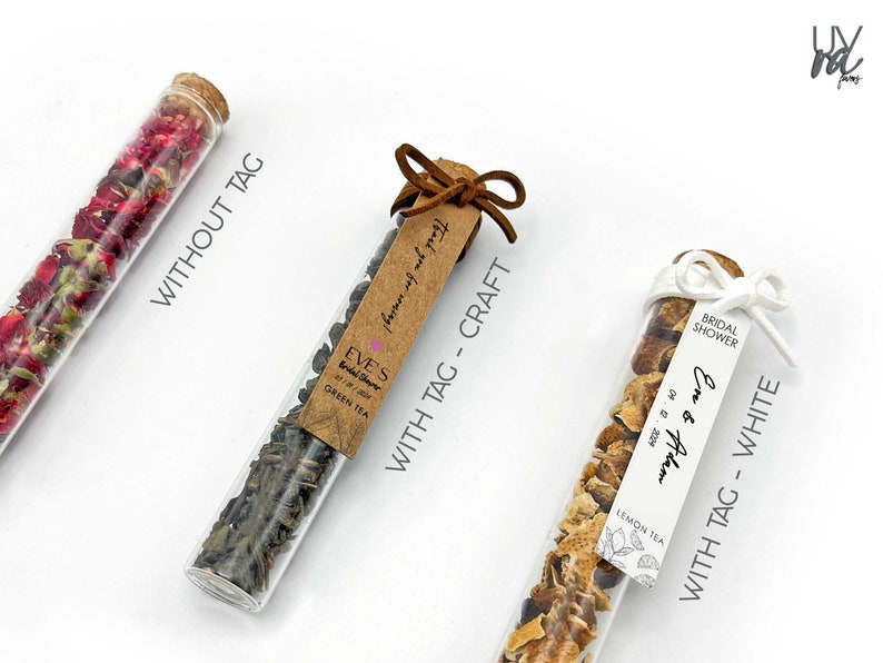 May include: Three glass test tubes filled with dried tea leaves and flower petals. The test tubes are tied with twine and a tag. The tags are labeled "Without Tag", "With Tag - Craft", and "With Tag - White".
