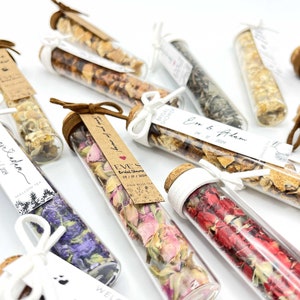 May include: Assortment of small glass tubes filled with dried flowers and herbs, tied with twine and a small tag. The tags have handwritten text, including "Bridal Shower", "Eve's", "05/1/2024", and "Thank you for coming!"