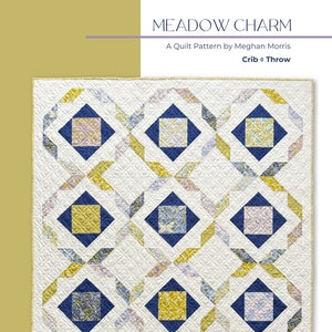 May include: A quilt pattern called "Meadow Charm" by Meghan Morris for a crib or throw. The quilt features a geometric design with blue, yellow, and pink floral fabric squares on a white background.
