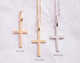 May include: Three gold cross necklaces, one in rose gold, one in yellow gold, and one in white gold. Each necklace has a simple, delicate chain.