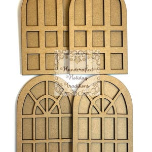 May include: Four unfinished wooden window cutouts with arched tops and rectangular panes. The windows are arranged in two rows of two, with the text "Handcrafted Holiday Traditions" visible on the image.