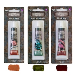 May include: Three tubes of Art Alchemy Antique Brilliance Wax in Red Amber, Lucky Emerald, and Fire Ruby. Each tube is 0.68 fl oz (20 ml). The packaging includes the product name and color.
