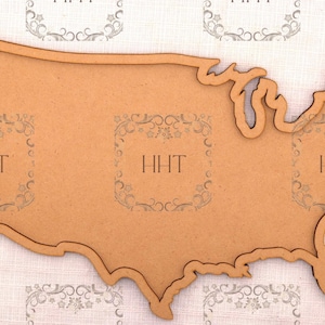 May include: A wooden cutout of the United States of America. The cutout is brown and has a slightly rough texture.