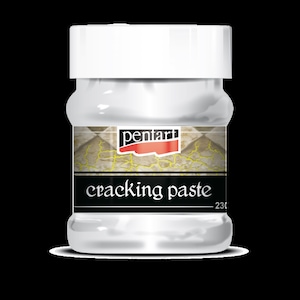 Puede incluir: Un tarro de plástico blanco de pasta craqueladora Pentart. El tarro tiene una etiqueta con el texto "cracking paste" y el logotipo de Pentart.