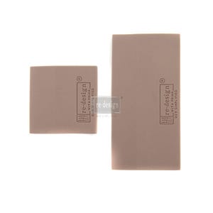 May include: Two rectangular pieces of brown craft paper with the text "re-design with Prima DIY Simplified" printed on them.