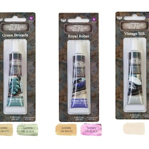 May include: Three tubes of Opal Magic Wax in Green Brocade, Royal Robes, and Vintage Silk. Each tube is in a rectangular package with the product name and a decorative image. The tubes are 20 ml.