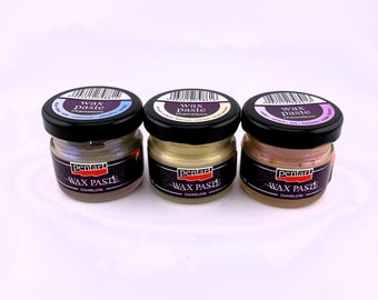 May include: Three small glass jars of Pentart Wax Paste Chameleon. Each jar has a black lid and a label with the product name. The wax paste colors are iridescent, with shades of gold, purple, and pink.