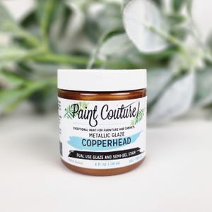 Pu&ograve; includere: Un barattolo di smalto metallico Copperhead di Paint Couture, uno smalto a doppio uso e una macchia semi-gel per mobili e armadi. Il barattolo &egrave; da 118 ml e ha un coperchio bianco. L'etichetta include il testo "Paint Couture" e "Copperhead".
