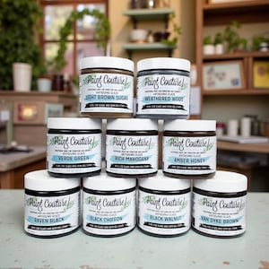 May include: A collection of Paint Couture antiquing glaze jars in various colors, including Light Brown Sugar, Weathered Wood, Verde Green, Rich Mahogany, Amber Honey, Raven Black, Black Chiffon, Black Walnut, and Van Dyke Brown. Each jar is 4 fl oz.