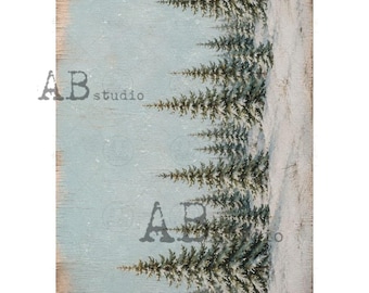 May include: A sheet of decoupage rice paper featuring a winter forest scene with green pine trees against a light blue sky and snow-covered ground. The text AB studio is printed in a dark grey font over the trees and the light blue background.