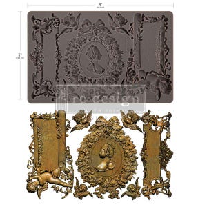 May include: A gray silicone mold with a rectangular shape, featuring ornate frames, floral designs, and a central cameo portrait. The mold is 8 inches (20.3 cm) wide and 5 inches (12.7 cm) tall. Below, a gold-colored example of the molded designs is shown.