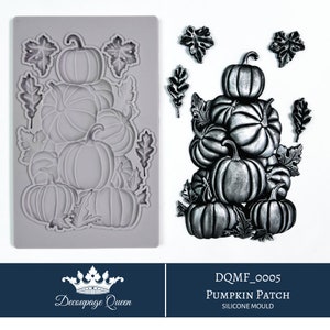 May include: A silicone mould for making pumpkin patch decorations. The mould is grey and shows a stack of pumpkins with leaves. The text "DQMF_0005 PUMPKIN PATCH SILICONE MOULD" is at the bottom of the image.