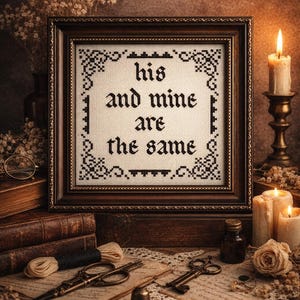 May include: A framed cross-stitch with the words "his and mine are the same" in black thread. The frame is dark brown, and the scene includes candles, vintage keys, and sewing tools, creating a cozy, romantic aesthetic.