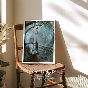 May include: A framed art print featuring a rainy street scene with a glowing streetlamp, a wooden bench, and a trolley car under mossy trees. The text OCTOLUX Art Studio is printed in white at the bottom of the frame against the dark artwork.