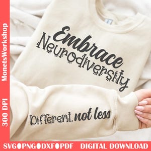 Könnte beinhalten: Beiges Sweatshirt mit dem schwarzen Schriftzug "Embrace Neurodiversity" auf der Brust. Der Ärmel zeigt den Satz "Different, not less." Das Bild enthält auch den Text "MonetsWorkshop" und "SVG PNG DXF PDF DIGITAL DOWNLOAD."