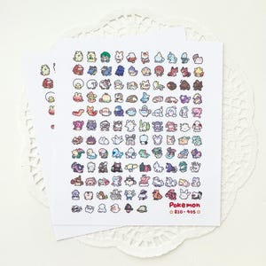 May include: A sheet of stickers featuring Pokemon characters from generations 8 and 9. The stickers are colorful and feature a variety of Pokemon, including some of the most popular characters like Pikachu, Charizard, and Squirtle.