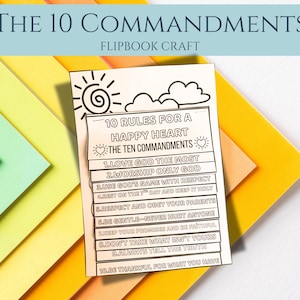 May include: A flipbook craft titled "The 10 Commandments" with the text "10 Rules for a Happy Heart." The flipbook is white with black text and illustrations, set against a colorful background of yellow, orange, and green paper.