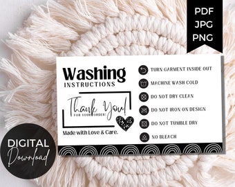 May include: A white card with black text and icons outlining washing instructions for a garment. The card reads "Washing Instructions" and "Thank You!" with a heart icon. The instructions include "Turn garment inside out", "Machine wash cold", "Do not dry clean", "Do not iron on design", "Do not tumble dry", and "No bleach".