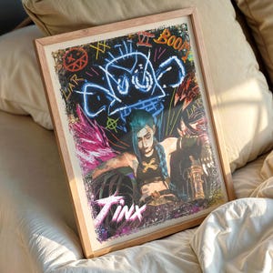 May include: Framed art print featuring a character with blue hair and a black top, set against a graffiti-style background with the word "Jinx" at the bottom. The artwork is in a wooden frame.