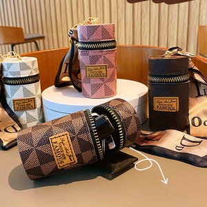 Louis Vuitton, a monogram Trousse kit de voyage' travel kit with  inflatible pillow and eye mask. - Bukowskis