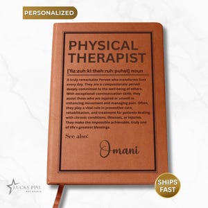 May include: A tan rectangular notebook with a dark brown border and text printed on the front cover. The text defines a physical therapist as a person who transforms lives, followed by the name Omani written in a cursive script font.
