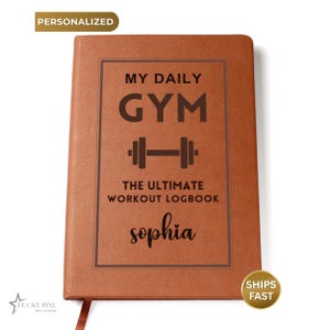 May include: A tan leather-like notebook with a dark brown rectangular border. The cover features the text "MY DAILY GYM", a dumbbell icon, the text "THE ULTIMATE WORKOUT LOGBOOK", and the name "sophia" in a script font printed in dark brown.