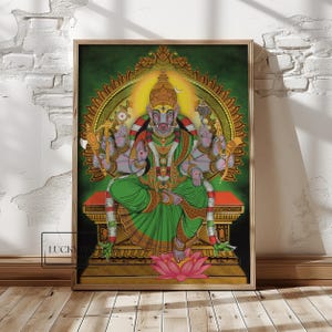 May include: A framed artwork depicting a multi-armed deity with a pig-like face, seated on a throne. The figure is adorned in green and gold garments, with a halo and lotus flower. The background is a gradient of green and gold.