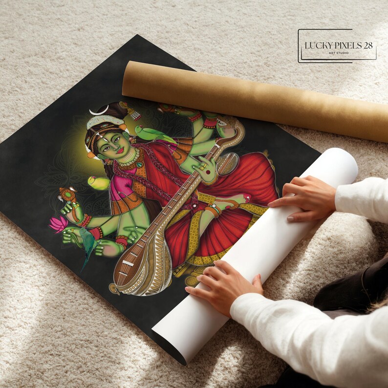 May include: A colorful painting of a Hindu goddess playing a stringed instrument, a veena, with four arms. She is wearing a red and gold sari and has a green complexion. The painting is on a black background and has a gold border. The text "LUCKY PIXELS 28 ART STUDIO" is in the upper right corner.