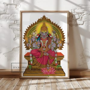 May include: A framed artwork featuring a deity with a boar's head, adorned with a crown and jewelry, seated on a throne. The figure is depicted in vibrant colors, with a pink garment and a golden halo. The artwork is set against a white background and a wooden frame.