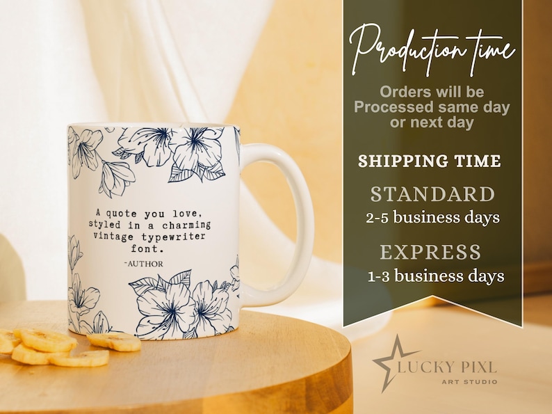 May include: A white ceramic mug featuring a dark blue floral pattern and the printed text: A quote you love, styled in a charming vintage typewriter font. -AUTHOR. The mug has a curved handle and is positioned on a smooth, rounded wooden surface.
