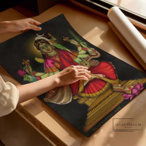 May include: A colorful illustration of a Hindu goddess playing a stringed instrument. She is depicted with four arms, wearing a red and gold sari, and sitting on a throne. The background is black with a gold halo around the goddess.