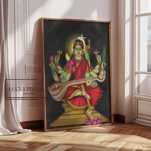 May include: A colorful painting of a Hindu goddess playing a veena, a traditional Indian string instrument. She has four arms and is adorned with flowers and jewelry. The background is dark green and the painting is framed in gold.
