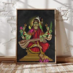 May include: A colorful painting of a Hindu goddess playing a stringed instrument. She is depicted with multiple arms, wearing a red and gold sari, and surrounded by birds and flowers. The painting is set against a dark background and has a gold frame.