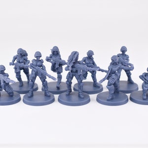 Pinup Corp Guardbabes with laser rifles (11 models) by Across The Realms. 32mm scale made to order 3D print.