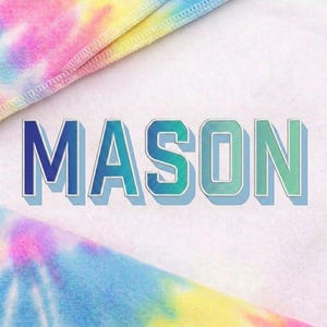 May include: The name "MASON" in blue and green gradient letters with a white outline and shadow. The letters have a textured appearance. The background is white with tie-dye fabric in the corners, featuring pink, yellow, and blue hues.