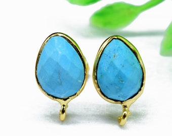 May include: A pair of gold-toned earrings with turquoise teardrop-shaped stones. The earrings have a simple design and are perfect for everyday wear.