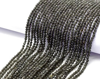 May include: A strand of dark gray faceted gemstone beads. The beads are small and uniform in size, and they are strung on a clear thread.
