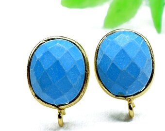 May include: A pair of gold-toned clip-on earrings with blue gemstone accents. The gemstones are faceted and have a round shape.