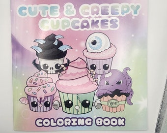 May include: A coloring book titled "Cute & Creepy Cupcakes" features illustrations of cupcakes with spooky themes. The cover art showcases cupcakes with monster and Halloween-inspired designs, including a skull, an eyeball, and an octopus. The background is a gradient of pink, purple, and blue.
