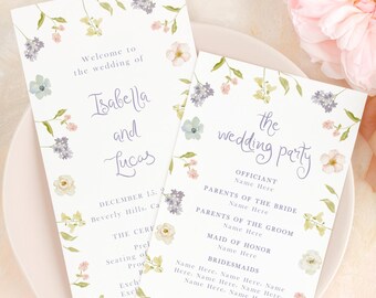 May include: Two wedding programs with floral designs and the names "Isabella and Lucas" are displayed on a white plate, surrounded by flowers and silverware. The programs include the text "Welcome to the wedding of" and "the wedding party."