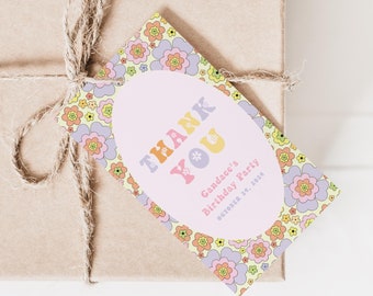 May include: A thank you gift tag with a floral design in shades of pink, yellow, and orange. The tag has a pink oval with the text "THANK YOU" in rainbow letters and the text "Gwendolyn's Birthday Party December 1st, 2018".