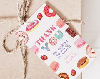 May include: A thank you gift tag with a donut theme. The tag is white with pink, blue, and yellow donuts and the text "THANK YOU for making my party so sweet! Love, Rachel".